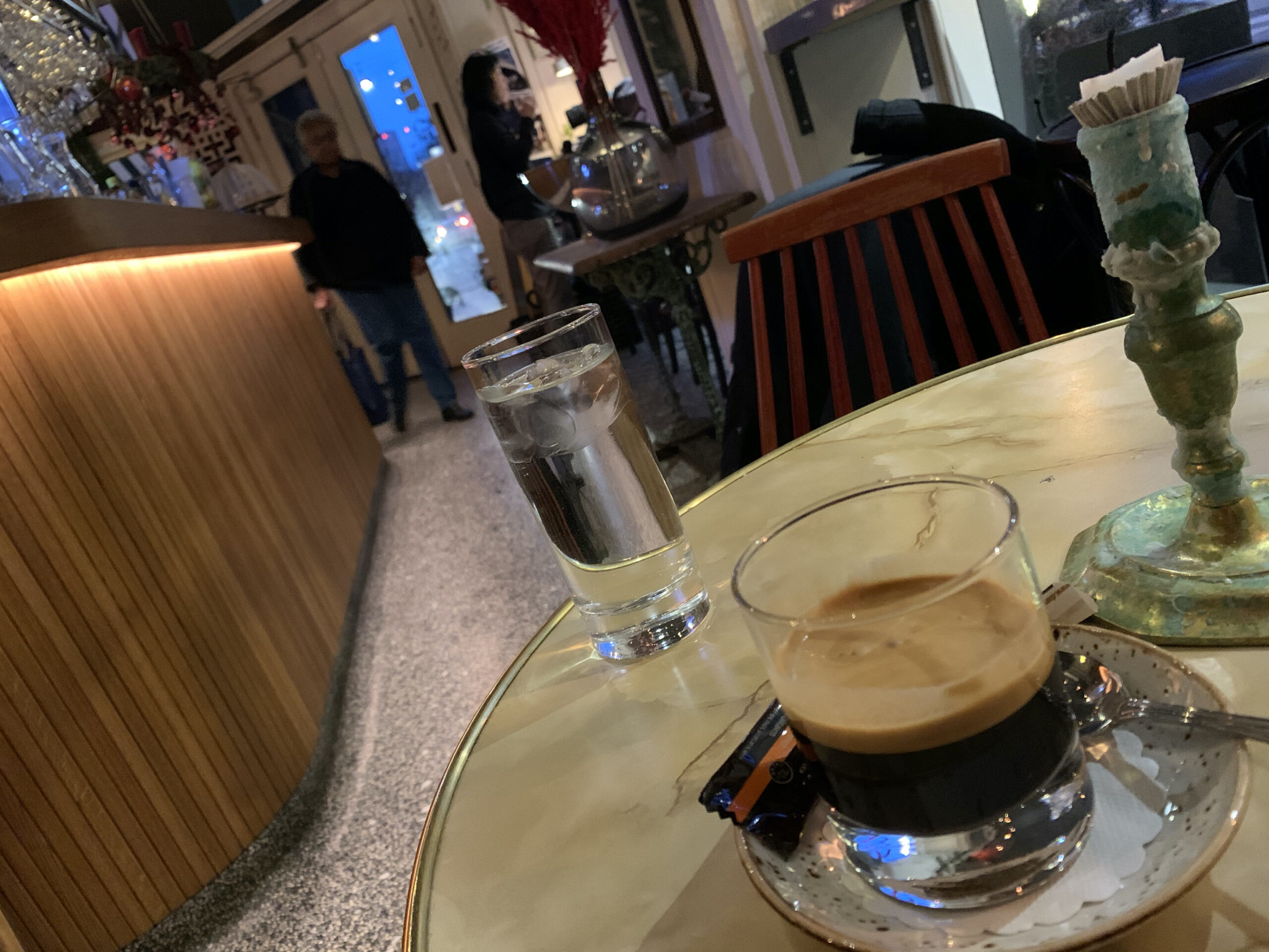 Cup of espresso coffee at a small European cafe table