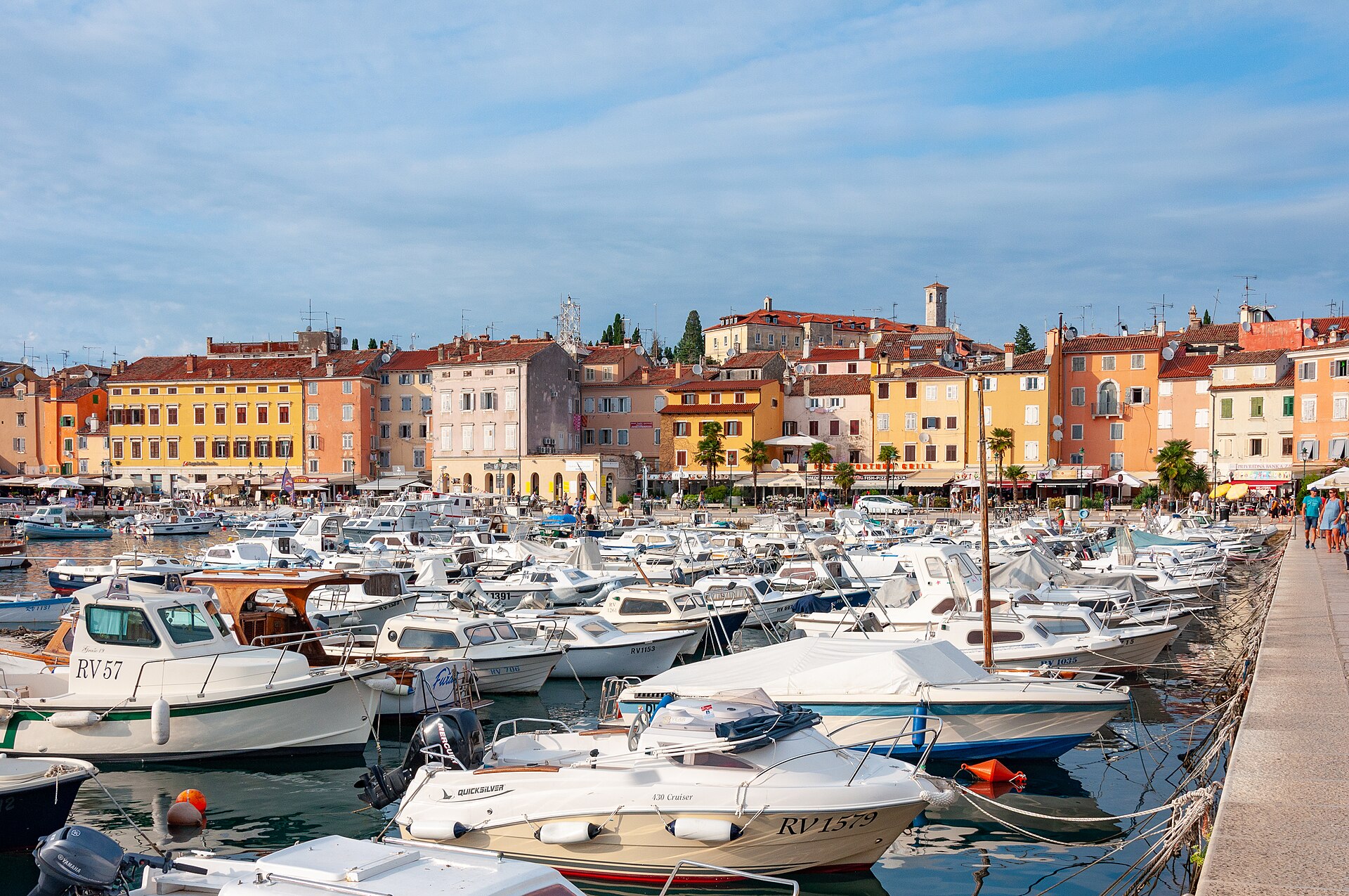 Small wooden boats moored in Rovinj harbour in front of the Old Town